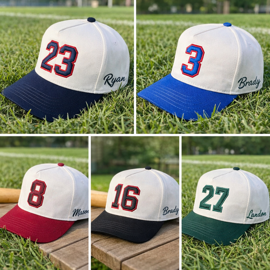 Customized baseball caps with numbers and names on a grassy background